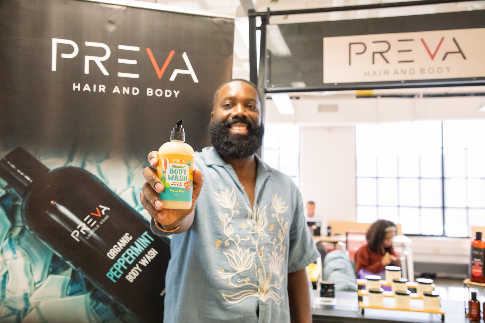 Image of Preva Boday owner hold up one of his products towards the camera