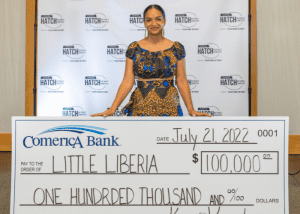 Ameneh Marhaba of Little Liberia standing with $100,000 check