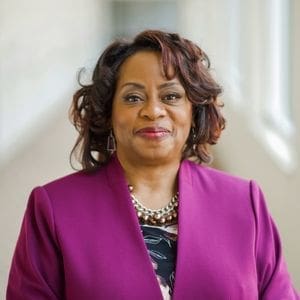 A woman of color smiling for a headshot