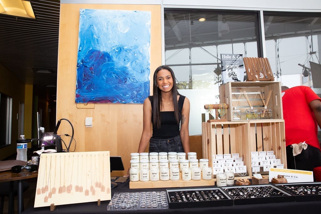 Image of Halie and Co, owner at a pop-up shop with all of her jewelry